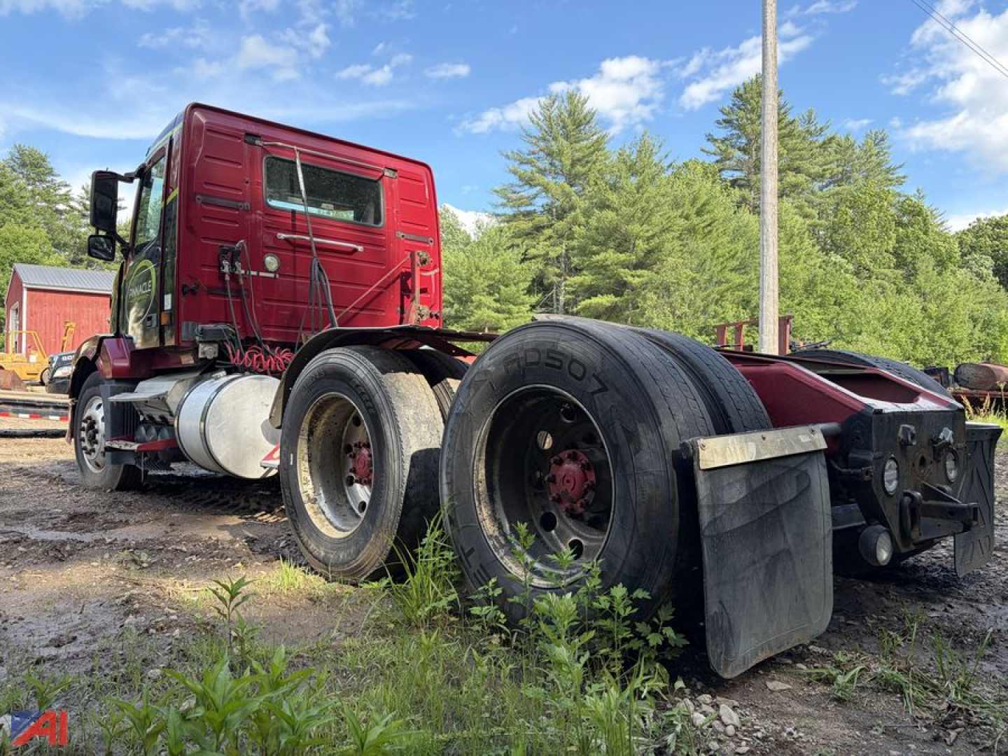 Volvo VNL tractor cab and rear wheels showing side view with fuel tanks, dual rear axles on a used truck.