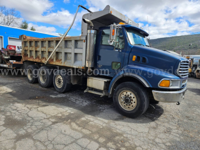 Dump truck showing LT9500 Sterling with blue cab and silver dump bed, side view, stock number 32136-93.
