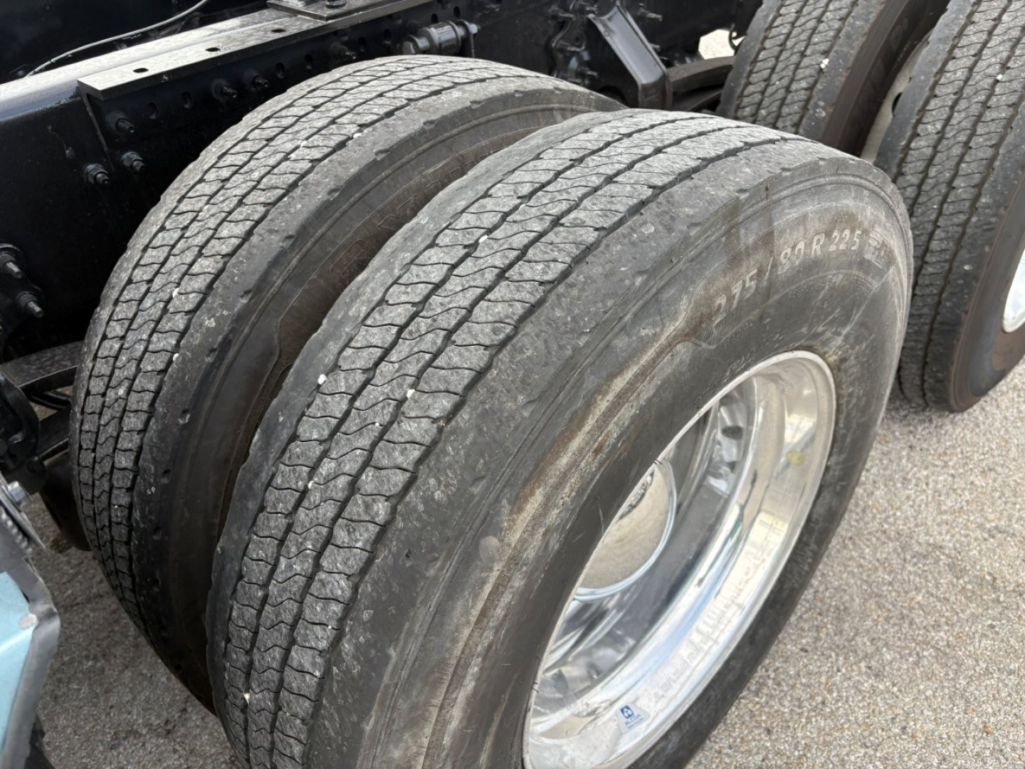Volvo VNL64T760 truck dual rear tires with tread detail and chrome wheel, part of a sleeper tractor chassis.