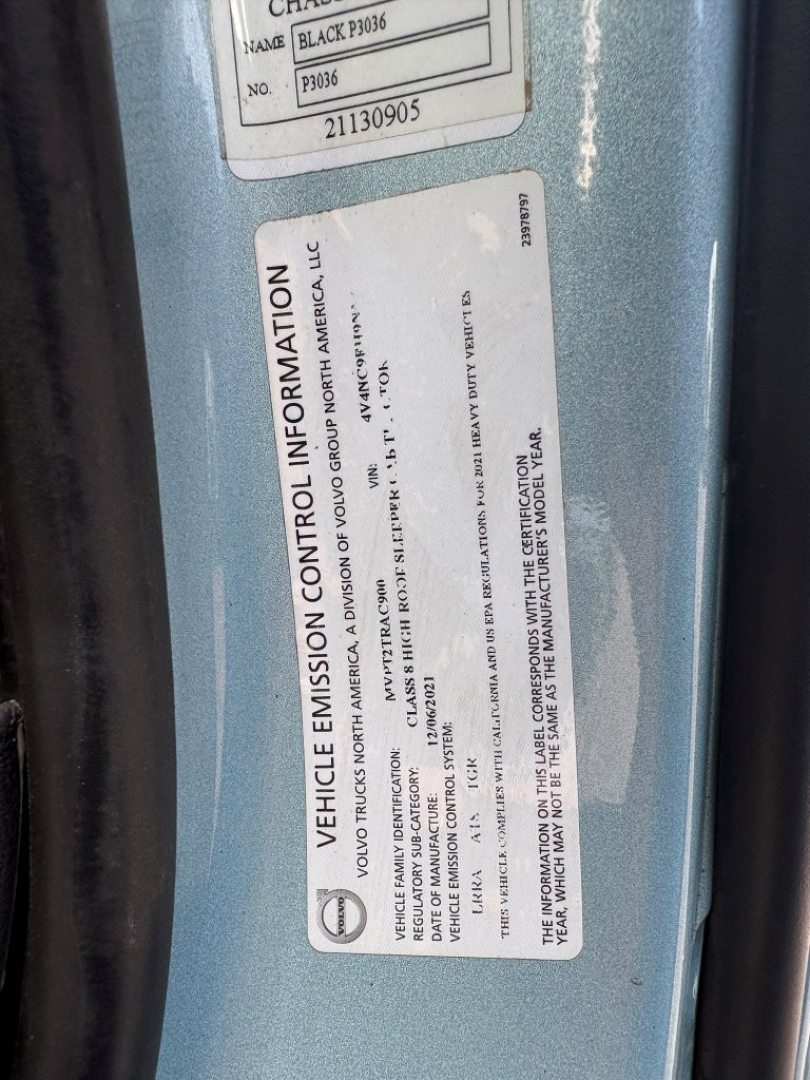 Vehicle emission control information label on Volvo VNL64T760 showing federal EPA details and VIN-4V4NC9EH9NN605505 with a blue truck door frame.