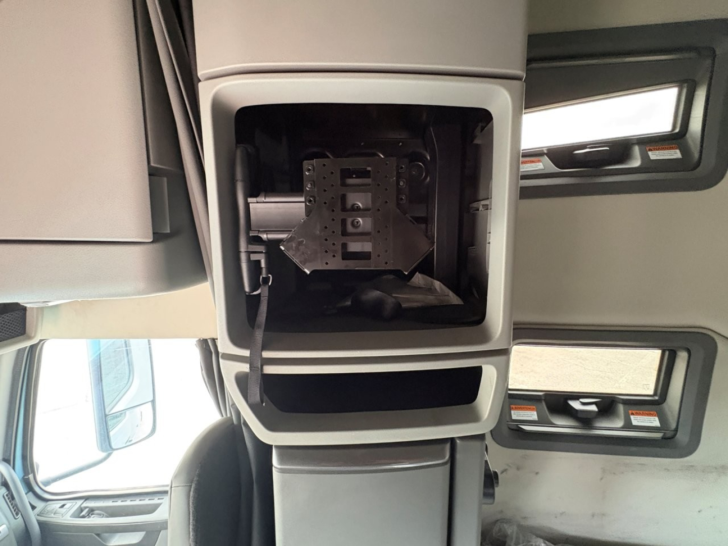Volvo VNL64T760 interior overhead shelf area with storage compartment and control panel