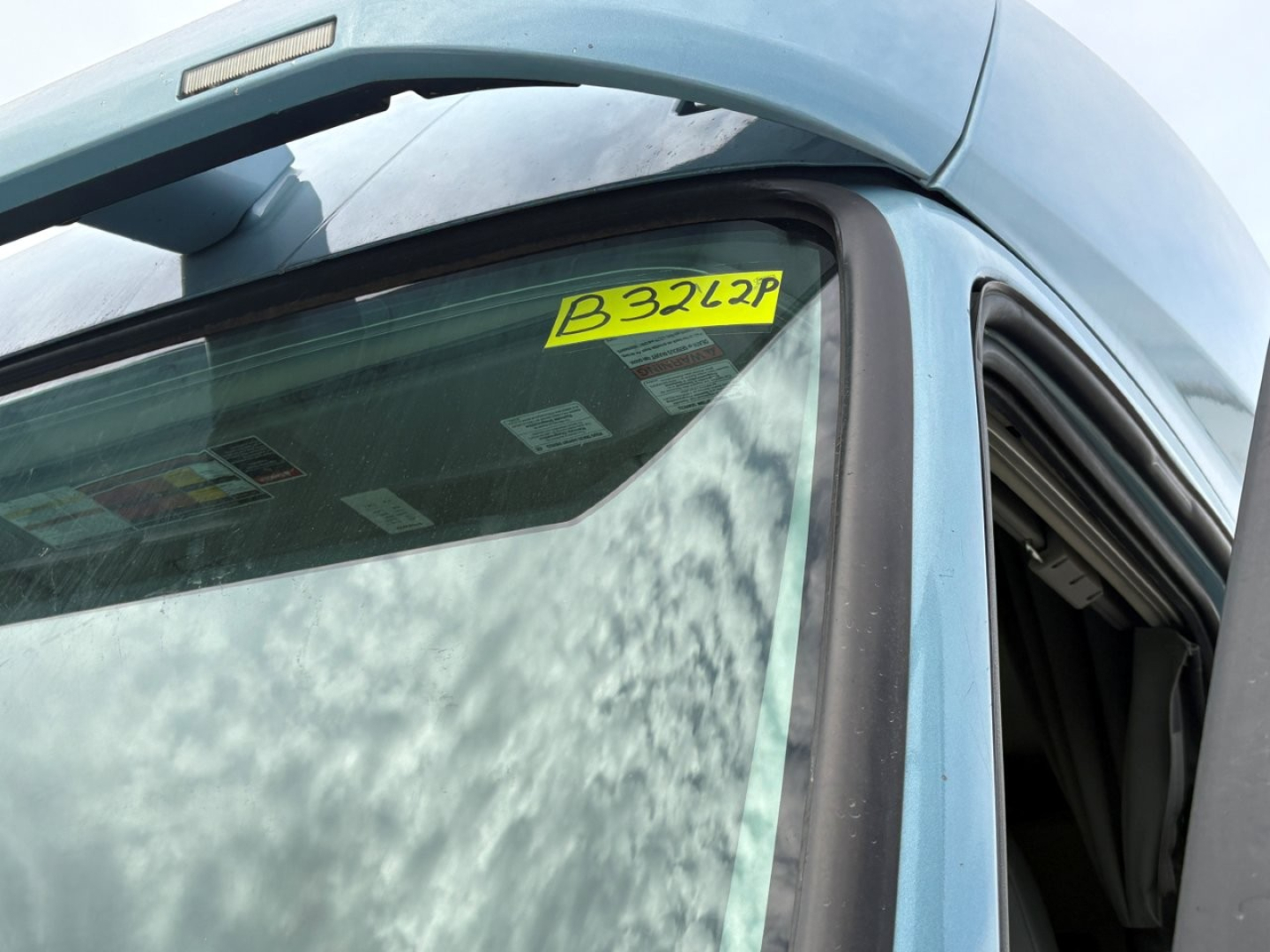 Volvo VNL64T760 sleeper cab truck window with yellow stock sticker B3262P