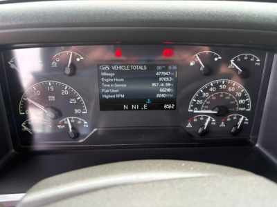 Dashboard of a Volvo VNL64T760 showing vehicle total readouts on a center display including mileage and hours.