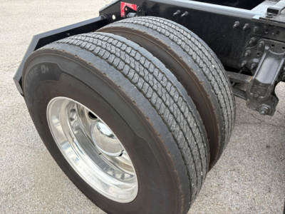 Volvo VNL64T760 tractor axle with dual rear tires and chrome wheel showing chassis components.
