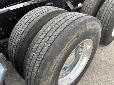 Volvo VNL64T760 truck dual rear tires with tread detail and chrome wheel, part of a sleeper tractor chassis.
