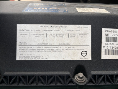 Label on Volvo VNL64T760 engine area showing engine family and model information plate with serial numbers and vehicle details.