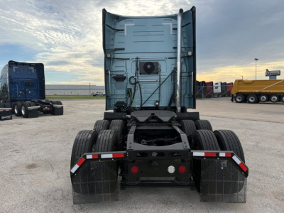 Rear view of a Volvo VNL truck cab chassis showing dual rear axles, fifth wheel area, and mud flaps.