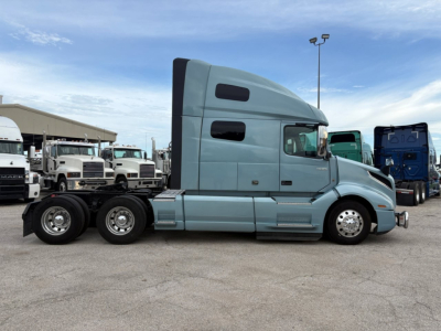 Volvo VNL64T760 sleeper tractor side profile showing cab and rear wheels with light blue exterior.