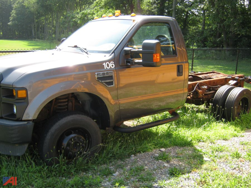 Ford F-350 Super Duty cab and chassis side view showing front cab with orange clearance lights and chassis behind, number 106 on door.