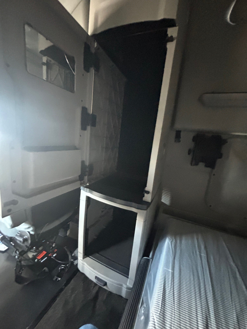 Peterbilt 579 cab interior view showing open storage compartment and step area