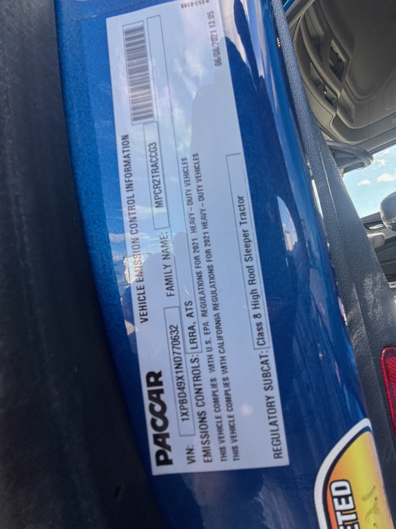 Peterbilt 579 VIN/SAFETY label close-up showing vehicle information and serial numbers on a blue truck door jamb.