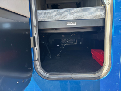 Peterbilt 579 cab interior showing storage area and PASS-THROUGH under bunk
