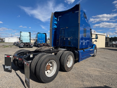 Peterbilt 579 conventional sleeper tractor in blue, rear view showing dual rear axles and cab