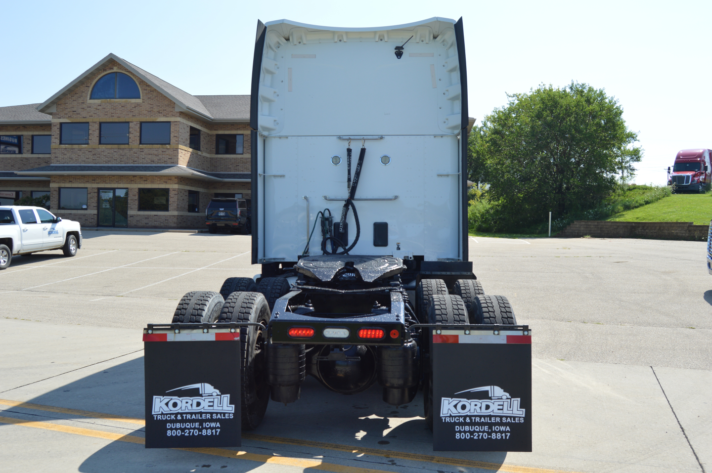 Rear view of a 2020 Peterbilt 579 truck cab and chassis with fifth wheel, dual rear axles, mudflaps labeled 'Kordell' displaying contact numbers.