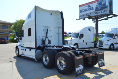 Peterbilt 579 tractor truck rear view showing fifth wheel and dual rear axles in a dealership lot.