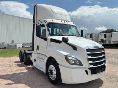 Truck cab showing Freightliner Cascadia 126 day cab front quarter view with white exterior and grille, no trailer in sight.
