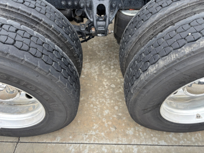 Kenworth T680 truck chassis showing tandem rear axles and dual tires with rims.
