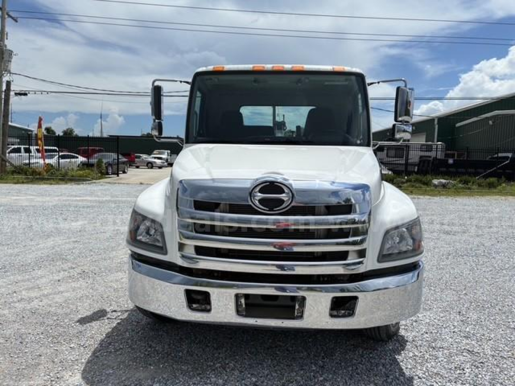 Front view of a white 2018 Hino conventional cab truck showing chrome grille, headlights, and bumper.