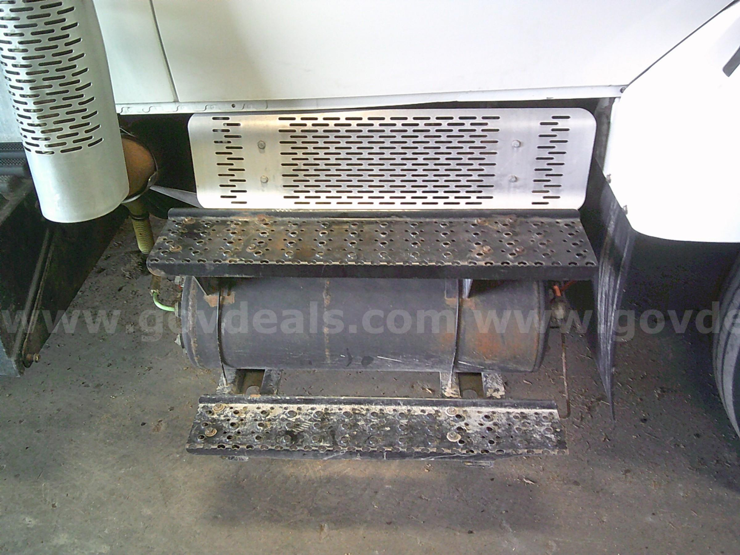 International WorkStar 7400 truck side step and fuel/air intake area with perforated metal guard and access steps.