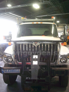 International WorkStar 7400 dump truck front view showing grille, bumper, and tow hooks.