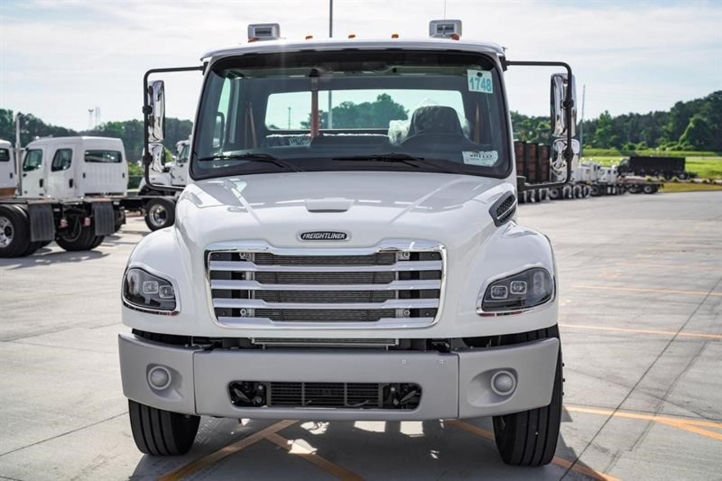 Front view of a 2027 Freightliner M2 106 Plus cab and chassis showing front grille and headlights.