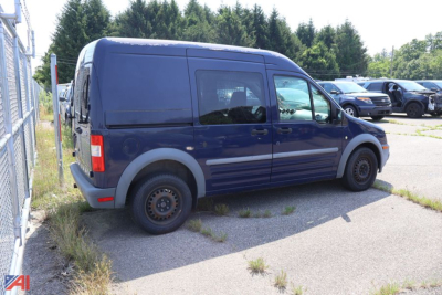 Ford Transit Connect cargo van side view, blue, passenger side with rear sliding door, 2011 model year label.