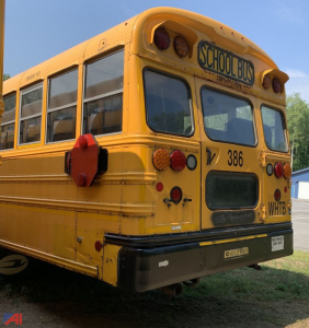 Back of a yellow 2017 Blue Bird Vision school bus showing rear with taillights, license plate area, and school bus sign; bus number 386 and WHTB on the back.