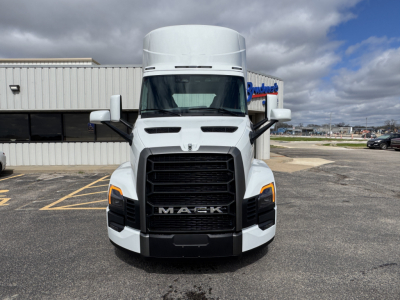 Mack PR64T truck front view showing bold grille, headlights, and side mirrors.