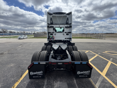 Rear view of a 2026 Mack PR64T tractor showing the fifth wheel and dual rear axles; empty cab with exposed components and mud flaps citing Bruckners Wichita, KS.