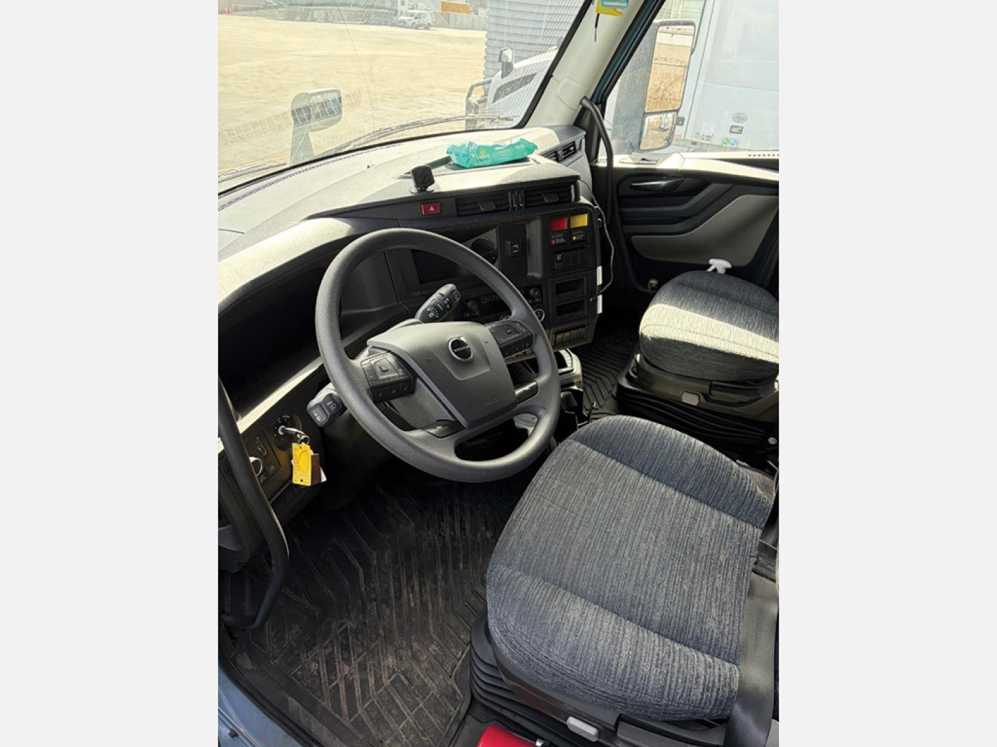 Volvo VNL 840 truck interior driver area with steering wheel and seat, cab view.