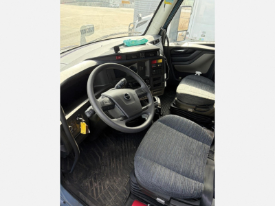 Volvo VNL 840 truck interior driver area with steering wheel and seat, cab view.