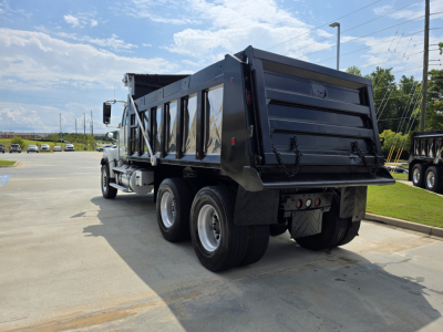 2022 Western Star 4700SF dump truck rear and side view showing dump bed and dual rear axles.