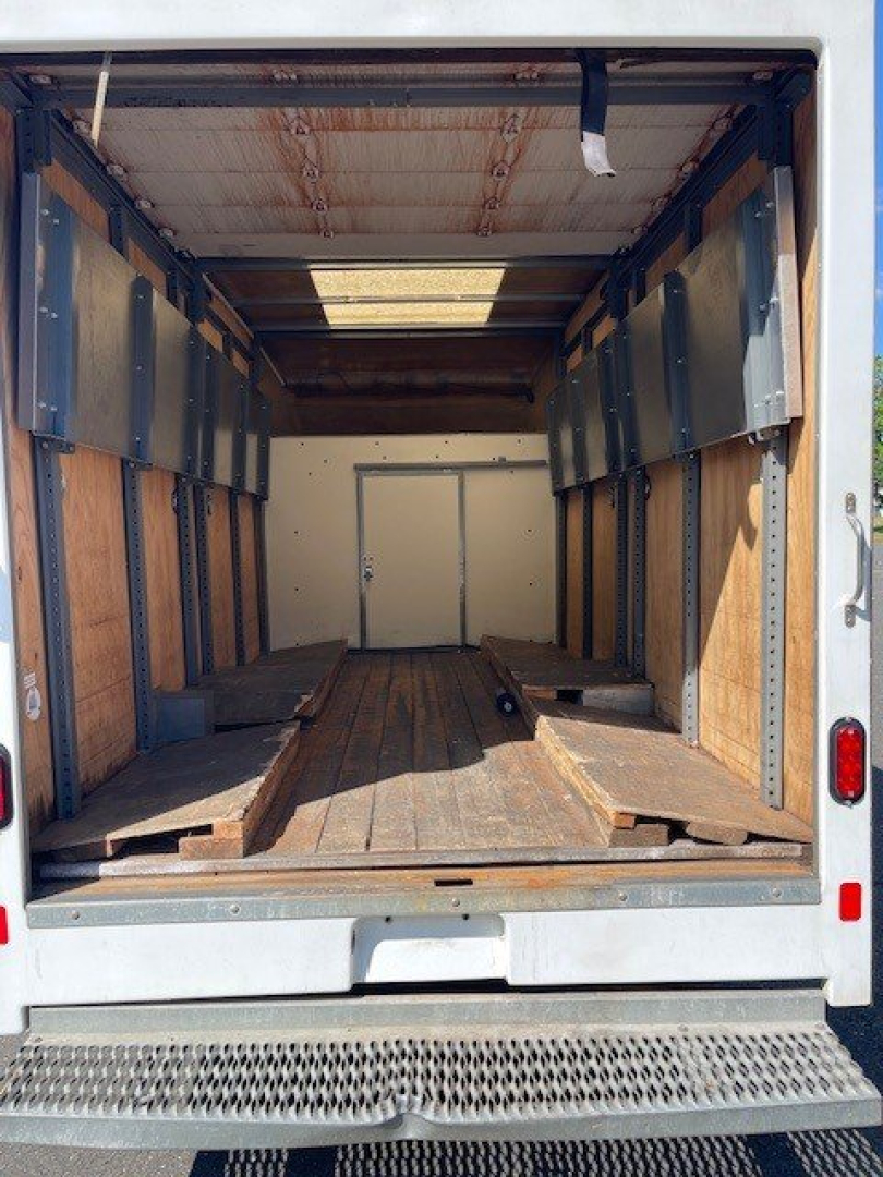 Truck cargo area of a 2022 Ford E-Series Cutaway showing an empty box van interior with wooden floor and metal sidewalls.