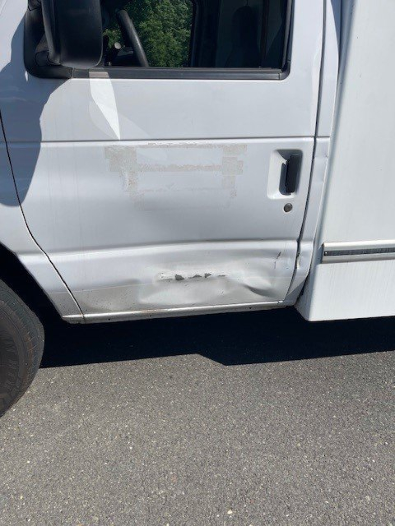 Ford E-Series Cutaway truck door with lower panel damage and dents