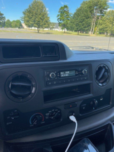 Dashboard of Ford E-Series Cutaway showing radio unit and HVAC controls.
