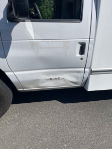 Ford E-Series Cutaway truck door with lower panel damage and dents