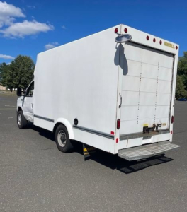 Ford E-Series Cutaway box truck rear view showing plain white cargo box, rear doors, step bumper, and taillights.