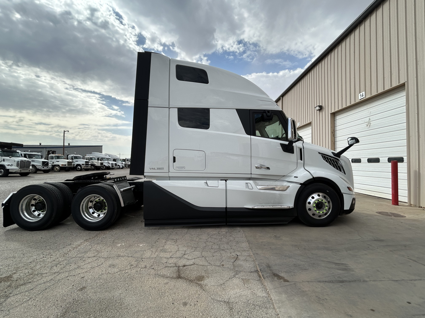 Volvo VNL64T860 conventional sleeper truck side view showing cab and dual rear axles.