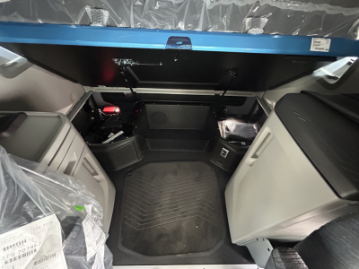 Volvo VNL64T860 cab interior cargo area with floor mat and storage compartments visible.