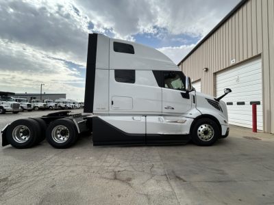 Volvo VNL64T860 conventional sleeper truck side view showing cab and dual rear axles.