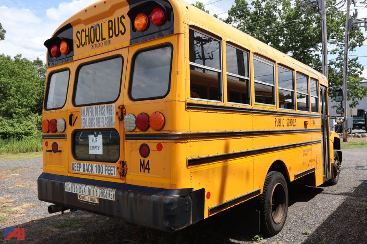 Yellow 2018 Blue Bird Vision school bus rear view showing school bus markings and taillights.