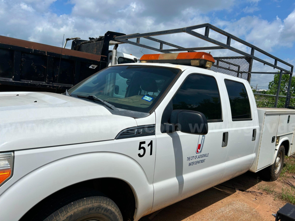 Ford F-250 service utility truck with orange beacon light rack on cab, side 51 number, utility bed, VIN 1FT7W2A62GEC16960 visible.