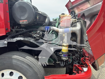 Volvo VNL64T670 engine bay showing air intake, coolant reservoir, and front suspension components.