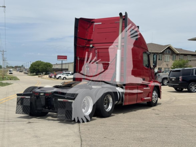 Volvo VNL64T670 sleeper cab truck in red, rear view shows tractor with black chassis and dual rear axles.