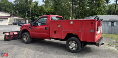 Red Ford F-250 Super Duty utility truck in-service with a plow mounted to the front and a utility bed featuring compartments.