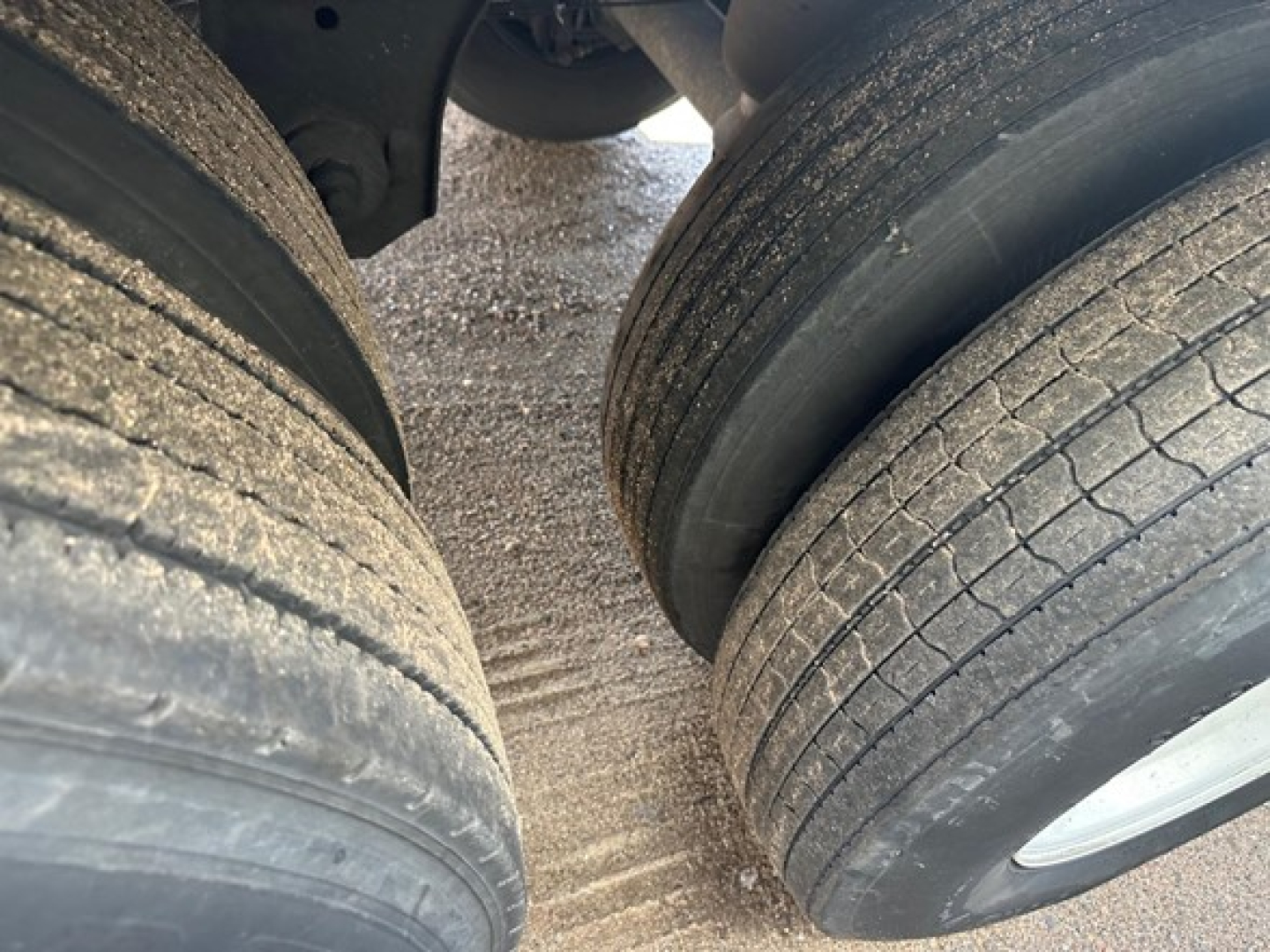 Dual rear tires on a used Great Dane Champion trailer viewed from ground level.