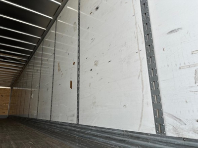 Trailer interior wall and floor of a 2022 Great Dane Champion trailer showing sidewall panels and steel stanchions.