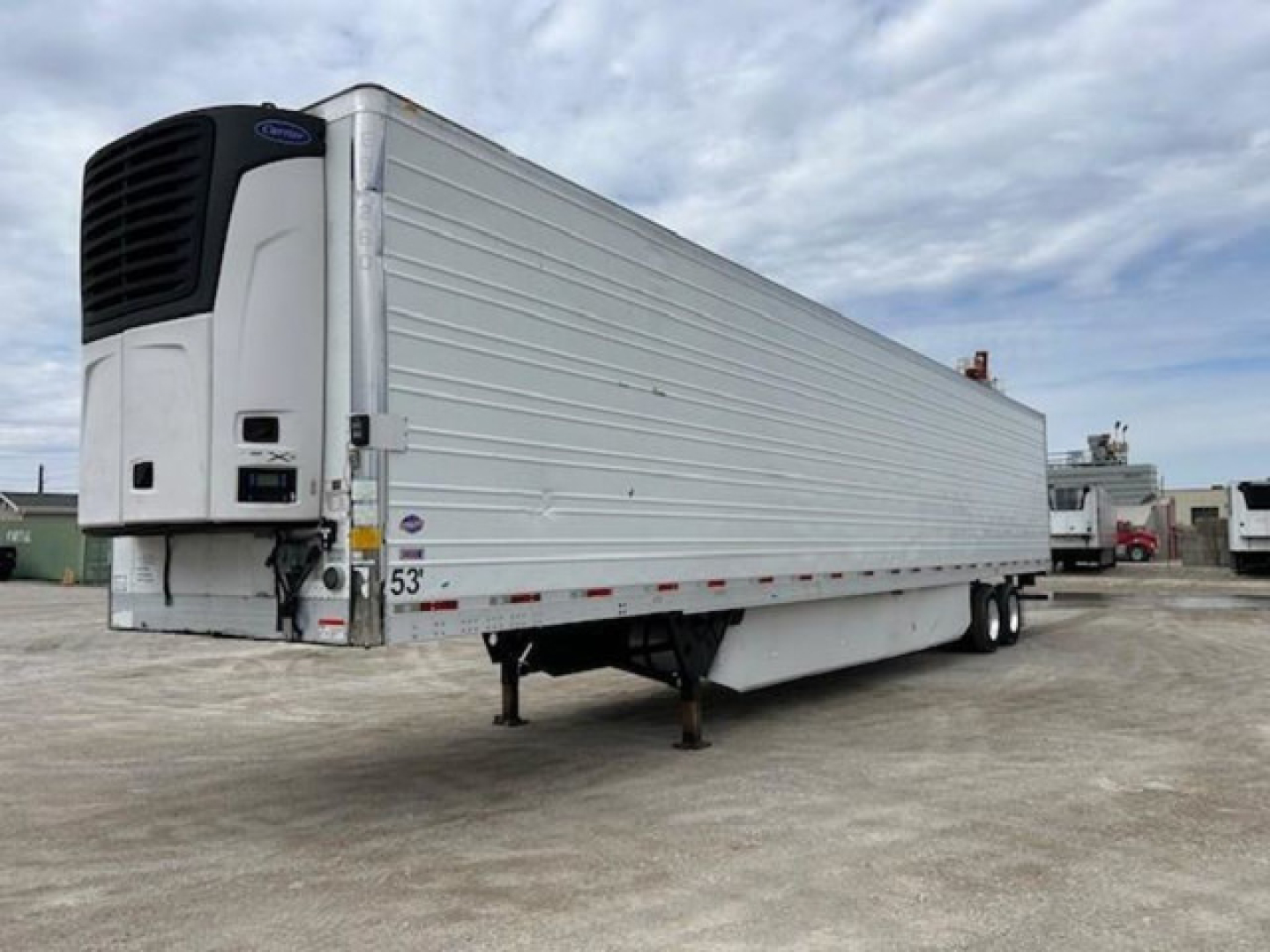 Utility reefer trailer showing refrigerated refrigeration unit at the front left and a white paneled body with landing gear undercarriage.