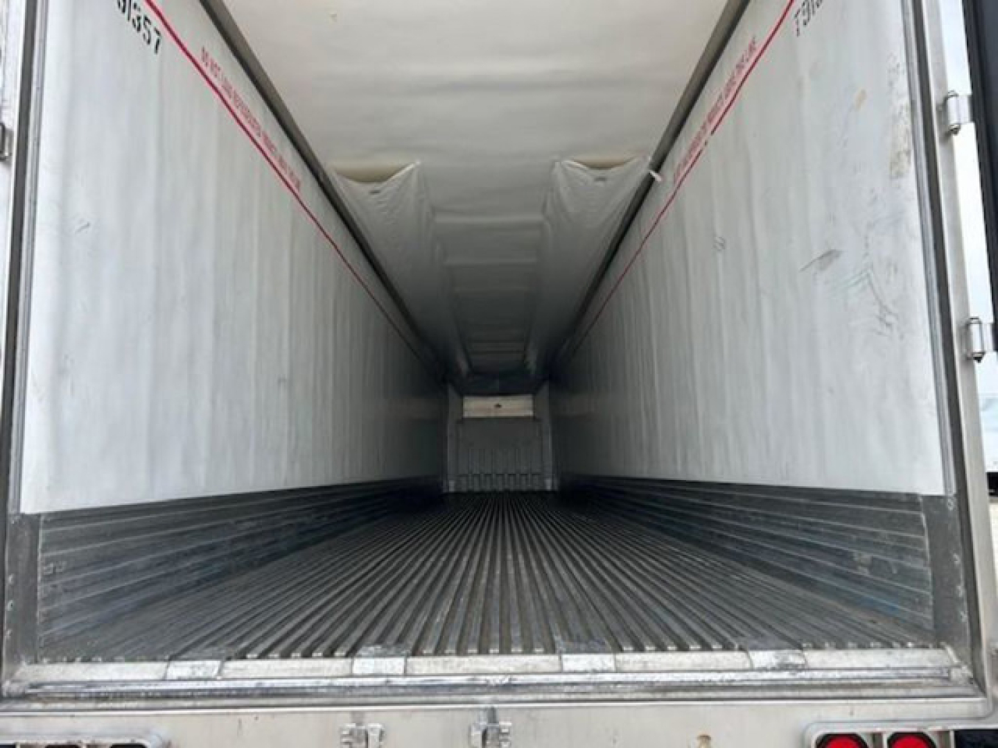 Trailer interior view of a 2019 Utility Reefer showing empty cargo area with ribbed floor and white interior walls.