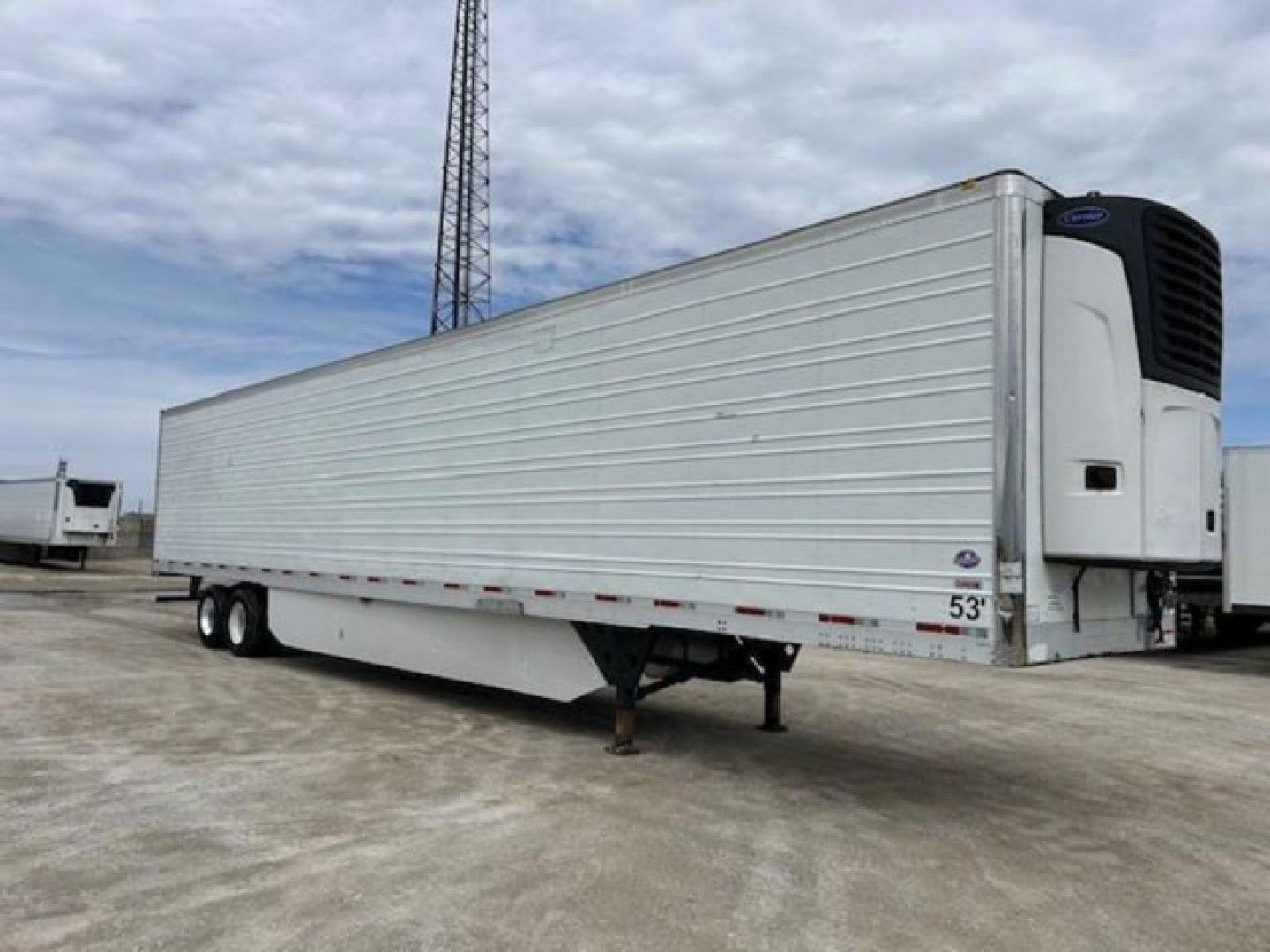 Utility reefer trailer 2019 with pulled dual-axle wheels and rear refrigeration unit, side view showing VIN label and stock number.